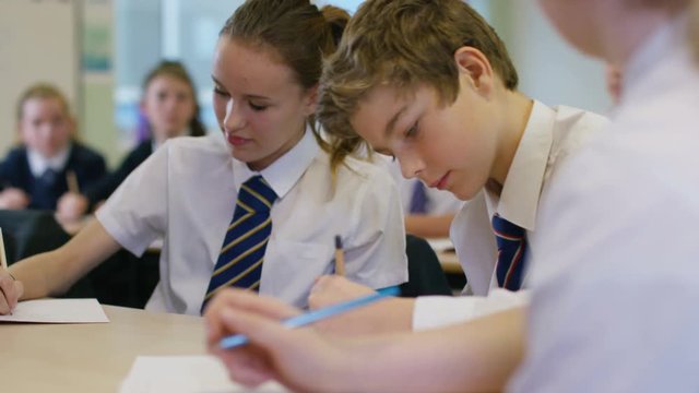  Young students working at their desks in school classroom