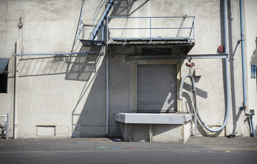 aged and worn vintage photo of industrial building with door