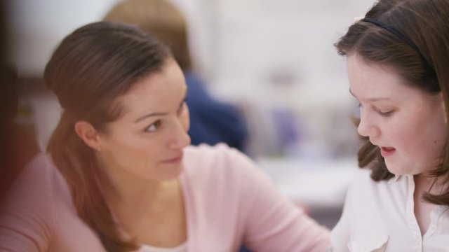  Teacher working with young pupils in school lesson