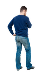 back view of Business man  looks.  Rear view people collection.  backside view of person.  Isolated over white background. bearded man in blue pullover thoughtfully leant finger to his chin.
