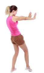 back view of woman pushes wall.  Isolated over white background. Rear view people collection. backside view of person. Sport blond in brown shorts pushes away someone.