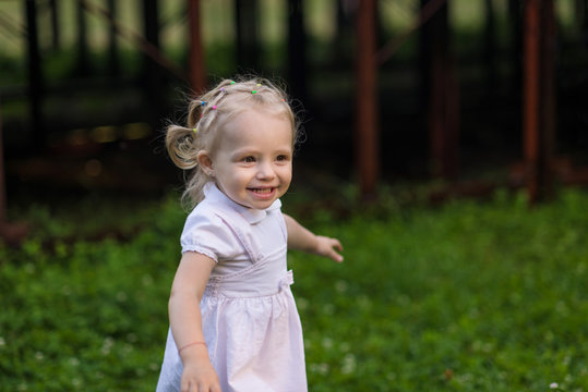 very emotional little girl walks in the summer park