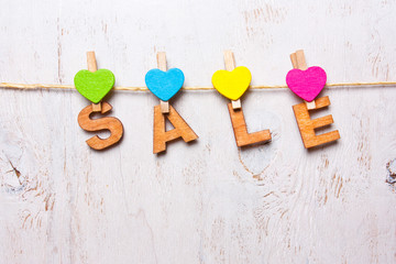 the word "sale" of wooden letters