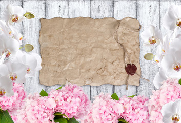 Hortensia with orchid and old paper on background of shabby wood