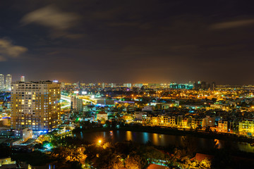 Fototapeta na wymiar Panoramic view of Ho Chi Minh city by night, Vietnam. Ho Chi Minh city (aka Saigon) is the largest city and economic center in Vietnam with population around 10 million people.