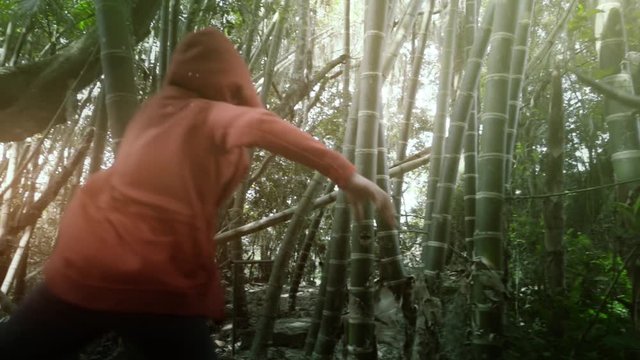 Woman runs  through the bamboo jungle in Colombia, Slow motion