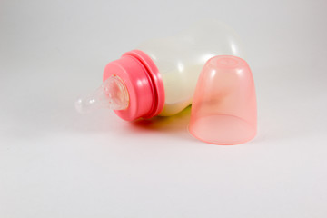 Baby bottle with milk on a white background