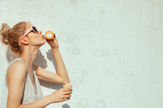 happy girl blowing soap bubbles