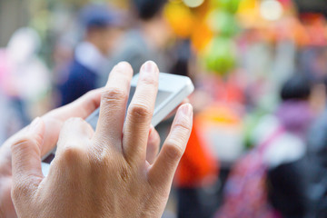 Close-up of a woman using smart phone with blurry background