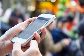 Close-up of a woman using smart phone with blurry background