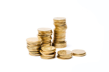 Several piles of monetary coins on a white background. Financial concept of investments and savings valuable metafishing. It is isolated on a white background.