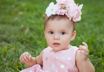 Beautiful baby with flowers on her head