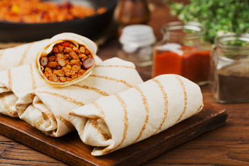 Burritos wraps with meat, beans and vegetables.
