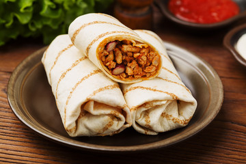 Burritos wraps with meat, beans and vegetables.