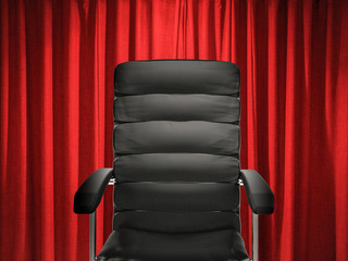 empty leather office chair on red curtain background