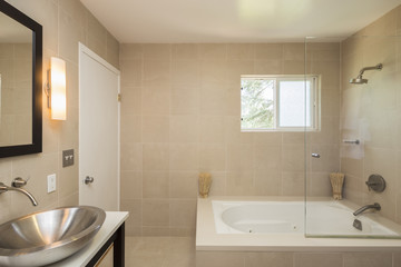 Fototapeta na wymiar Bathroom with oval modern metallic sink.