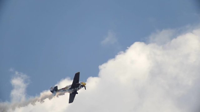 An old historical military soviet russia plane flying and performs aerobatics - goes up, slow motion