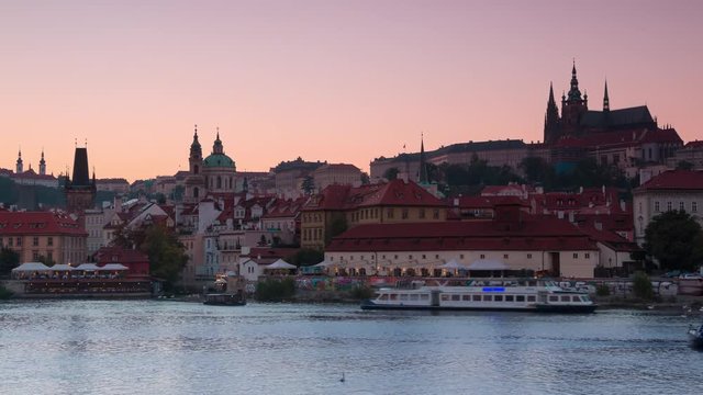 Czech Republic. Prague. Evening. View of the Vltava river with pleasure boats and city in background the Cathedral of St. Vitas. Time lapse 4K