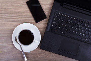 Lay flat image of a laptop and coffee cup