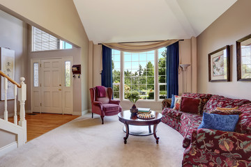 Open floor plan living room interior with lovely sofa and blue curtains