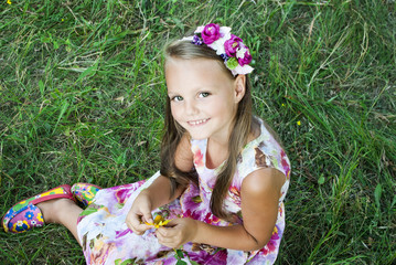 smiling girl sitting on the grass