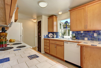 Kitchen interior. Maple cabinets and back splash trim.