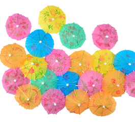 Fototapeta na wymiar Colorful paper cocktail umbrellas close-up on a white