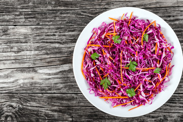 Salad coleslaw - red cabbage with carrots on white dish