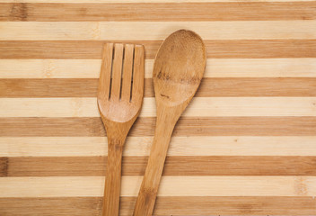 Wooden spoon and fork on wood texture