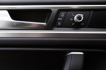 Fototapeta na wymiar Inner door handle, modern car interior detail