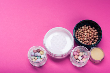 Set of colorful cosmetics on pink table
