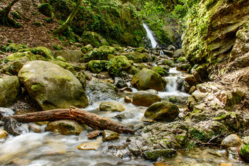 Attractive Waterfall and Green Moss Stone In Forest