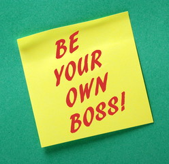 The phrase Be Your Own Boss in red text on a yellow sticky note as an incentive to take control of your business and be an entrepreneur