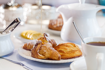 Breakfast with croissant coffee and honey