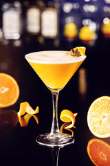 Fresh cocktail with orange in a martini glass