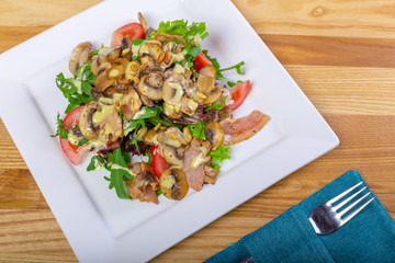 Warm mushroom salad with chilli and tomatoes