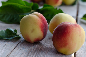 Ripe peaches on a gray wooden table