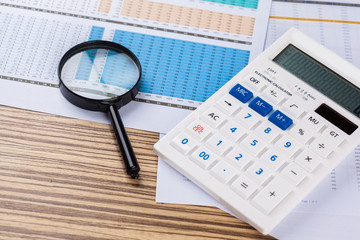 work with a magnifying glass, a calculator and papers