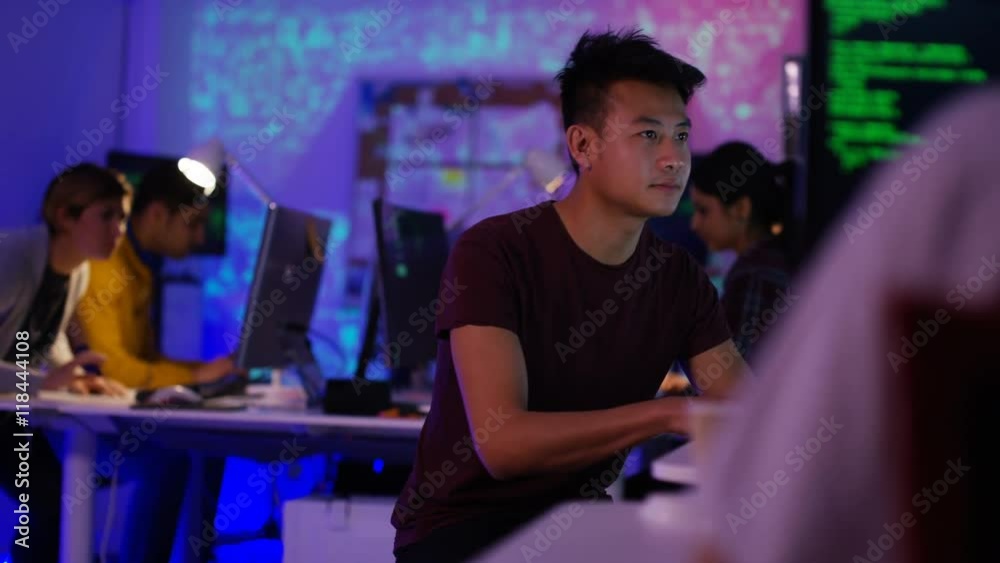 Wall mural young computer experts working in office with lots of computers