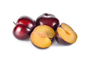 whole and half cut ripe plum on white background