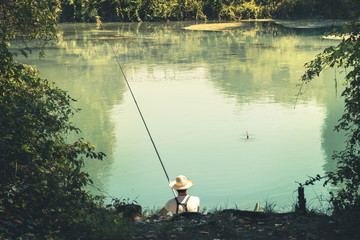 Obraz na płótnie Canvas fisherman in the water fishing in the river