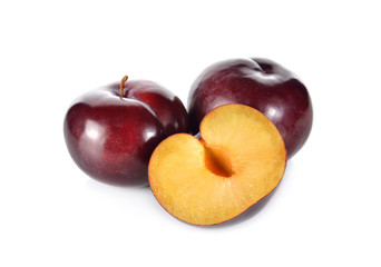 whole and half cut ripe plum on white background