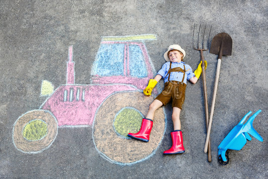 little kid boy having fun with tractor chalks picture 