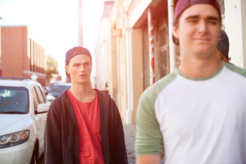 Guys skateboarders in street