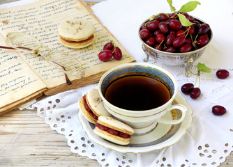cup of espresso coffee and French macaroons dessert stuffed with cornel on light wooden background