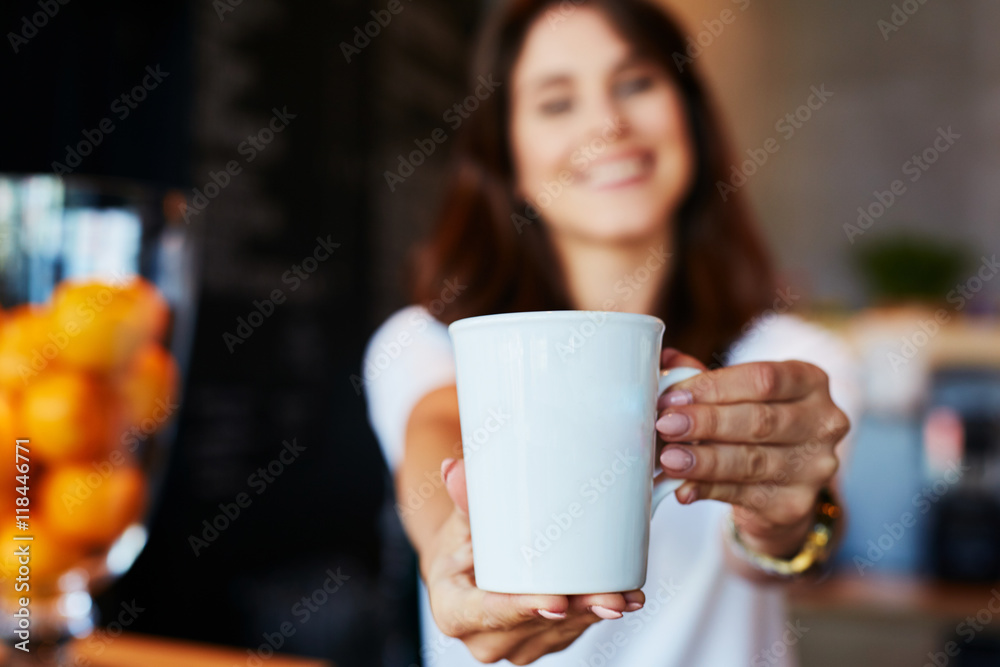 Wall mural waitress giving mug with coffee or tea