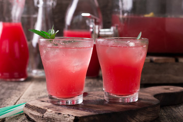 Watermelon drink in glasses with slices of watermelon mint and lemon, vintage background ,soft focus
