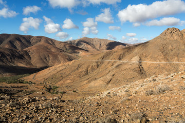 Beautiful volcanic mountains and the road on a mountain slope.  Road from la Pared to Betancuria . Fuerteventura. Canary Islands