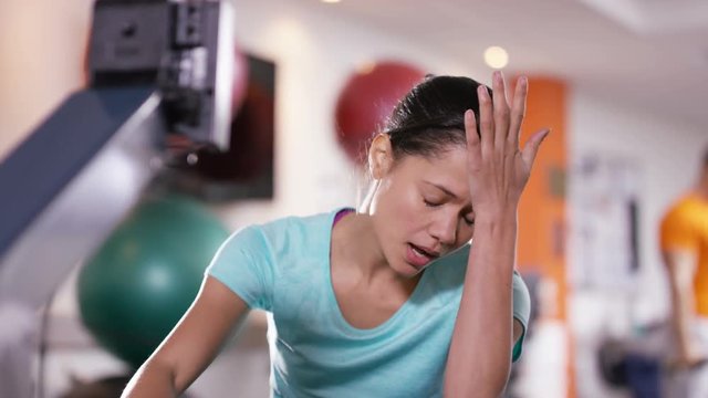  Woman working out on rowing machine at the gym