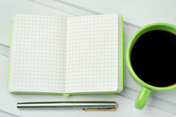 Empty notebook with cofee and fountain pen